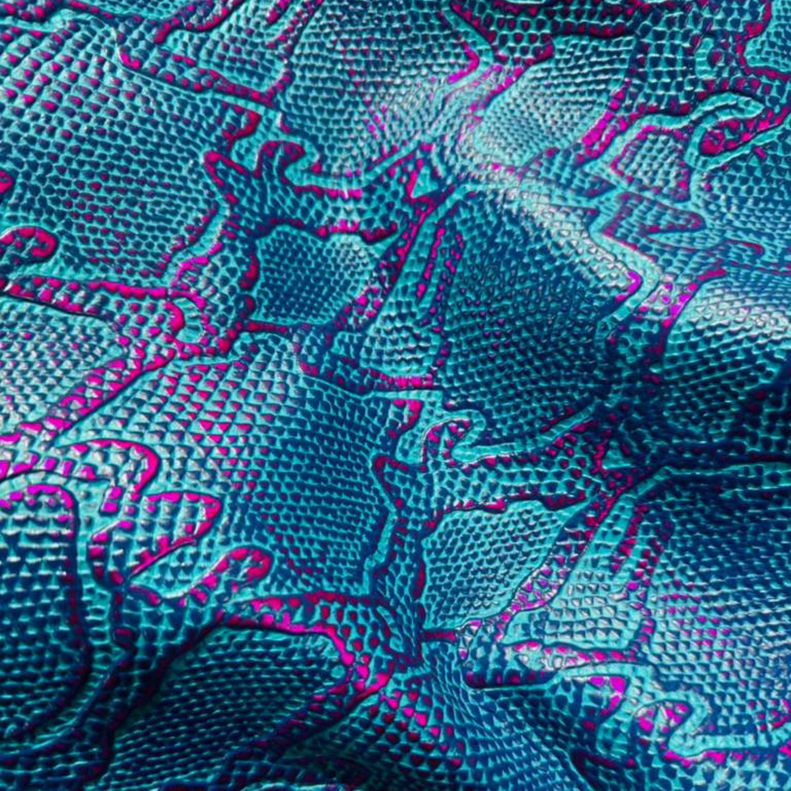 Turquoise and magenta Cascabel embossed leather with snakeskin texture, vibrant reptile pattern leather hide for handbags and artisan leather goods.